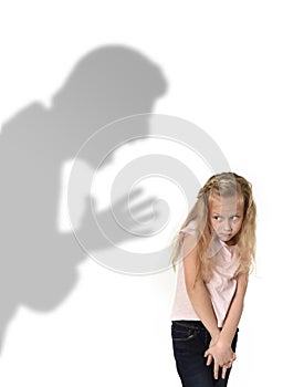 Father or teacher shadow screaming angry reproving young sweet little schoolgirl or daughter