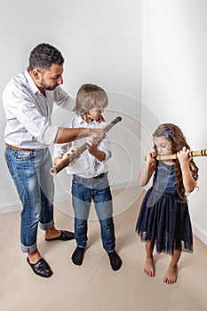 Father teaches children to play bamboo flute