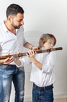 Father teaches son to play bamboo flute
