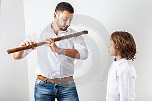 Father teaches son to play bamboo flute