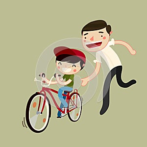 Father teaches son to ride a bike photo