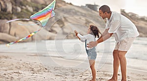 Father teaching child to fly a kite on beach wind with support, love and care. Helping, learning and fun outdoor with