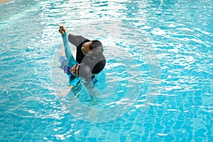 Father teaching daughter to swim