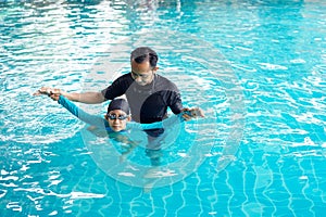 Father teaching daughter to swim