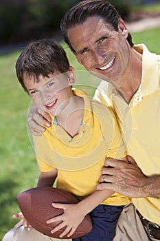 Father Teaching His Son To Play American Football