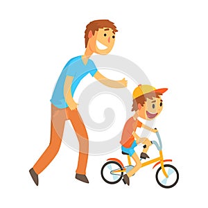 Father teaching his son to ride a bicycle photo