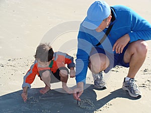 Father teaching his son to write photo