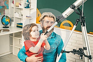 Father teaching son. Cute pupil with funny face hold Astronomy telescope.