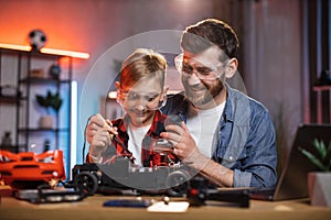 Father teaching son for soldering remote controlled toy car