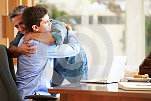 Father And Teenage Son Having A Hug