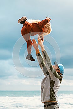 Father throws child up in the air happy family lifestyle outdoor dad and daughter playing together vacations