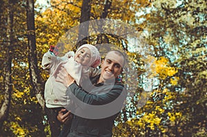 father with a toddler in the autumn park