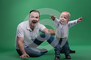 Father and toddler son playing around