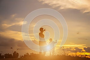 Father took the baby learn to walk at sunset