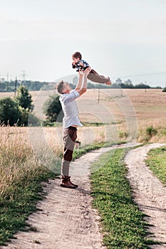 Father toss up his son . Vertical photo