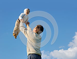 Father tossing baby