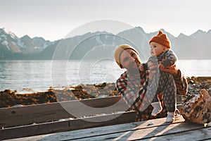 Father traveling with baby in Norway relaxing enjoying mountains view