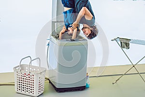 Father tries to wash his son in a washing machine standing upside down with his feet