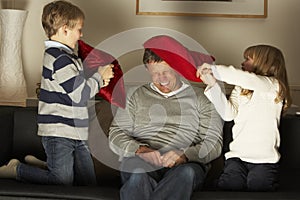 Father And Two Children In Pillow Fight