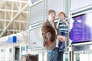 Father and two little sibling boys at the airport