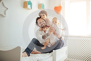 Father of two sons playing with a toy plane