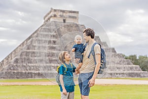 Father and two sons tourists observing the old pyramid and temple of the castle of the Mayan architecture known as