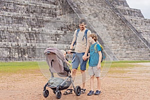 Father and two sons tourists observing the old pyramid and temple of the castle of the Mayan architecture known as