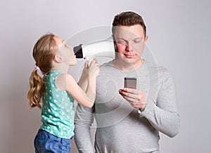 Father using smartphone ignoring his daughter