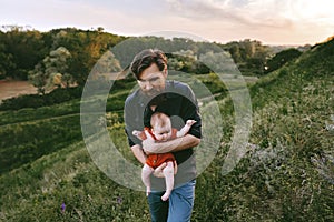 Father walking with infant baby outdoor family vacations