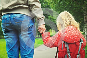 Father walking little daughter to school or daycare