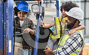 Father wearing safety hard hat, teaching children to drive tractor in factory to support his work as worker, playing, smiling,