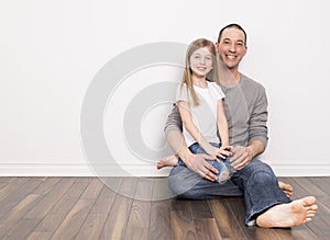 Father wit his daughter sit on the ground