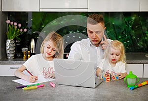 Father working from home with children around