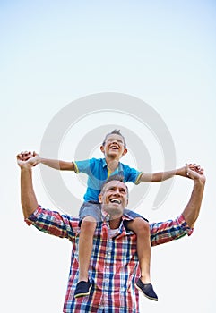 Father, young boy and shoulders of parents, sky and outdoors in park with smile. Laugh, love or bonding for son and dad