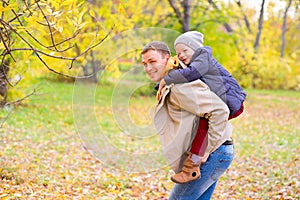 Father With Young Son On his back Autumn Park