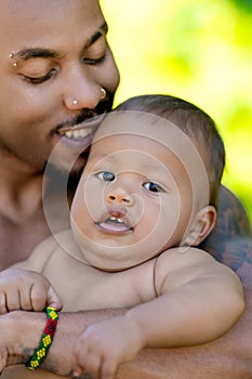 Fathers day. Close up portrait of african american father kissing multiracial baby. Father kiss Biracial child. Closeup