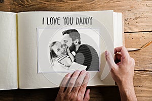 Fathers day concept. Photo album. Wooden background.