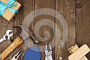 Fathers Day corner border of gifts, tie and tools on wood