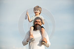 Fathers day. Dad and son playing together. Portrait of happy father giving son piggyback ride on his shoulders and