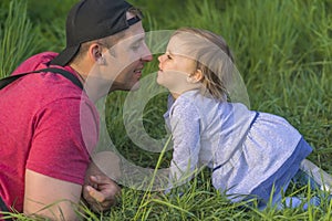 Fathers day. Father and his smiling happy daughter have fun at green park