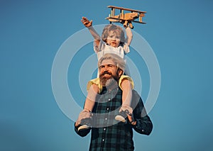 Fathers day. Father and son. Father giving son ride on back. Portrait of happy father giving son piggyback ride on his