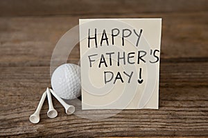 Fathers day greeting card with golf ball on table