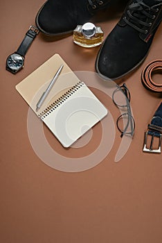 Fathers Day mockup with pen, perfume, belt, footwear, notepad and eyeglasses on brown background. Set of stylish male clothes and