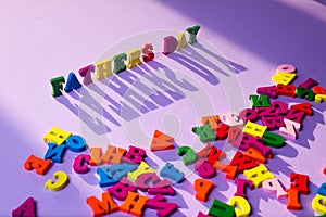 Fathers Day wooden letters in the sun on purple background