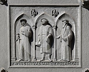 Fathers of the Reformed Churches of Switzerland: Zwingli, Vadian, Oecolampadius, door of the Grossmunster church in Zurich photo