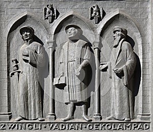 Fathers of the Reformed Churches of Switzerland: Zwingli, Vadian, Oecolampadius, door of the Grossmunster church in Zurich photo