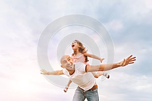 Fathrer and cute daughter playing like airplane