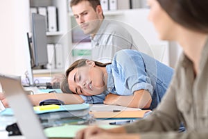 Fatigued employee sleeping at office photo