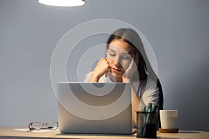 Fatigued and overworked woman dozing and wanting sleep at work