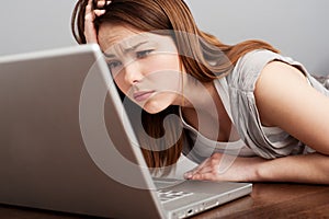 Fatigued student looking on laptop